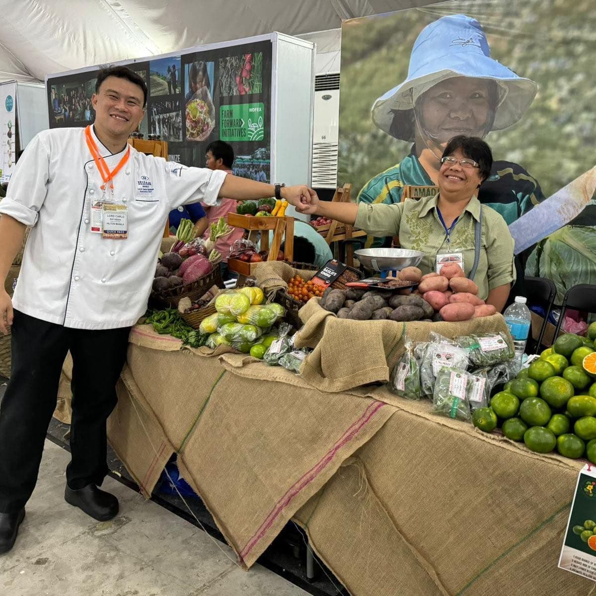 A chef and a farmer cooperative representative at a produce stall