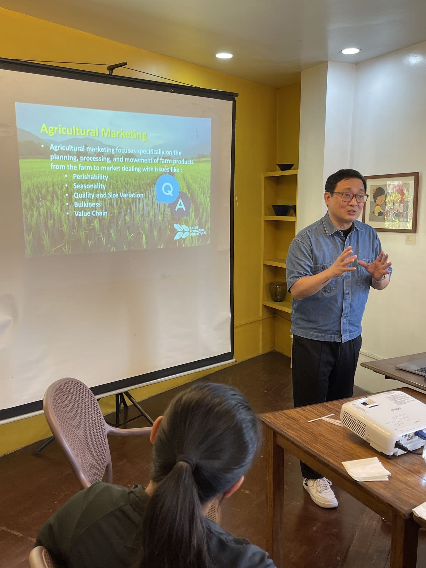 An FFI facilitator leading a training session with farmer cooperative members