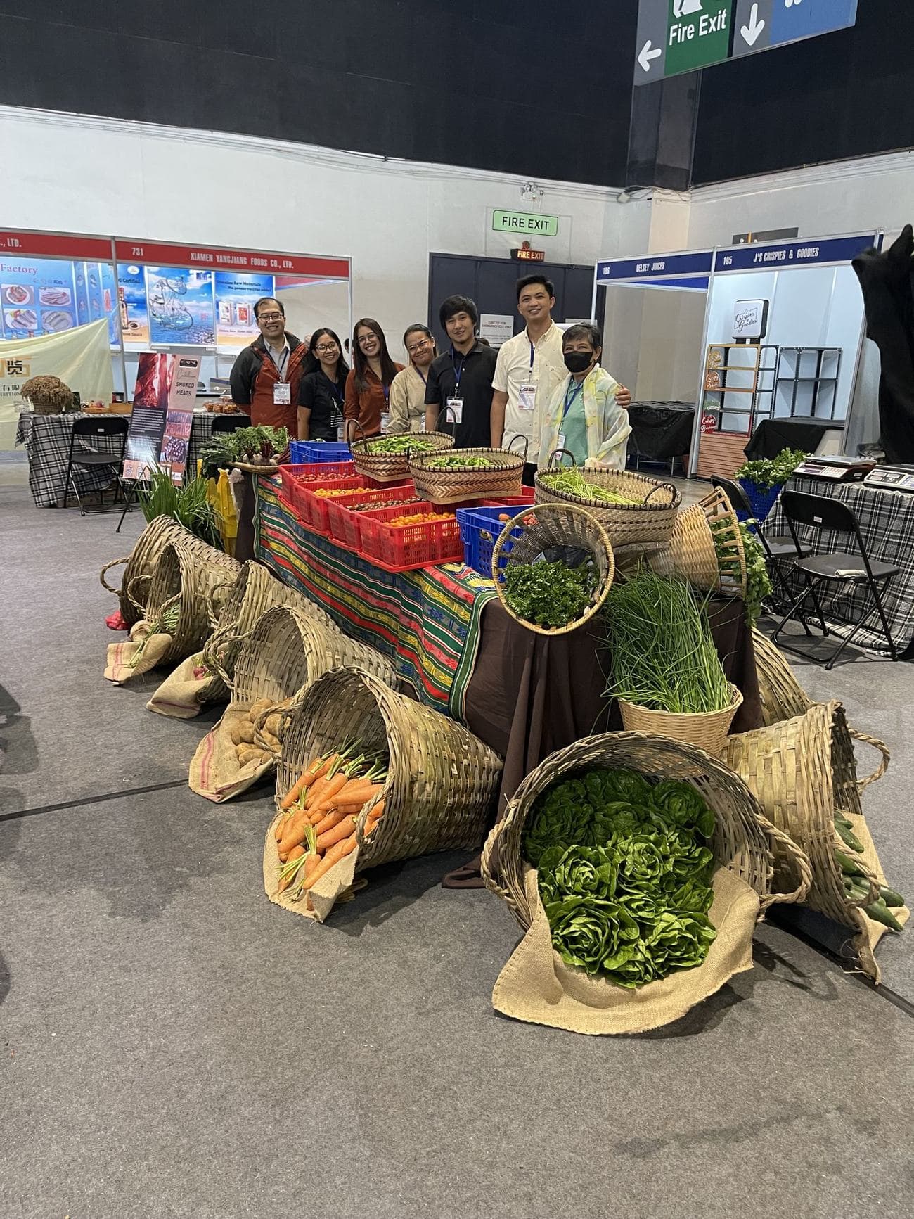 FFI farmer partners exhibiting fresh produce at a WOFEX trade fair booth